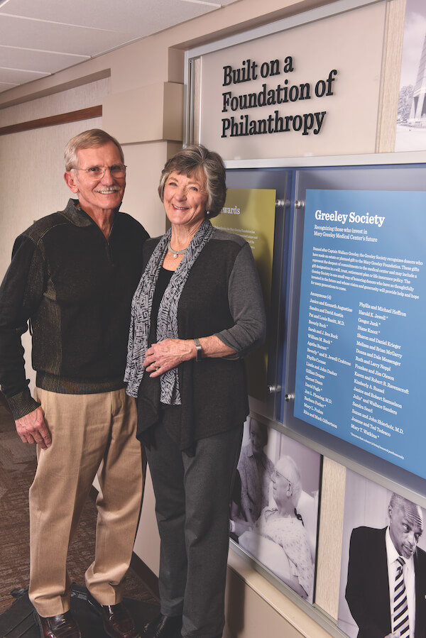 Shierholz, John and Suzy by foundation donor wall